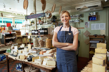 Owner Of Delicatessen Standing In Shop