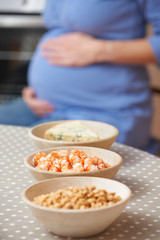Pregnant Woman Looking At Foods To Be Avoided During Pregnancy