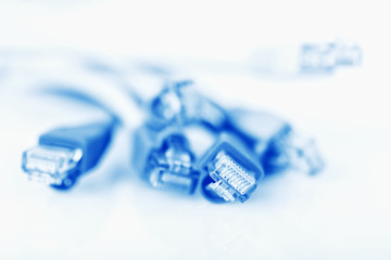 Colorful network cable with RJ45 connectors, blue network cable. Selective focus.