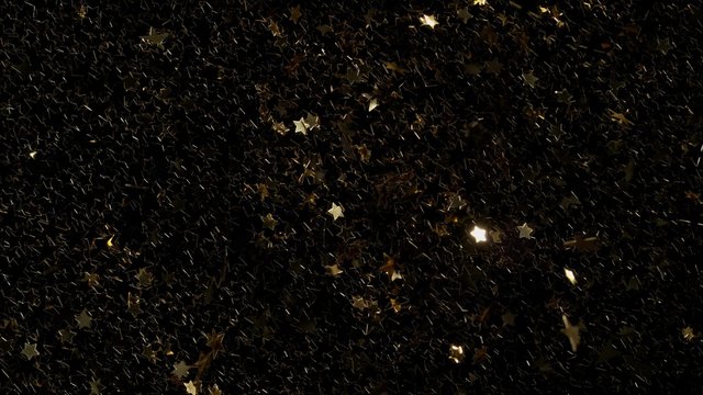 Star shpe confetti fly after being exploded against black background. Shot with high speed camera, phantom flex 4K. 4K 30fps. Slow Motion.