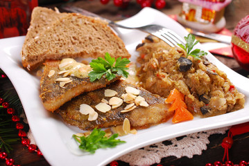 fried carp with almonds and sauerkraut for christmas eve