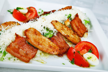 Salad with grilled chicken on white plate