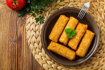 Meat croquettes served with fresh vegetables.