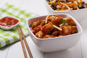 Fried chicken pieces in batter with sweet and sour sauce