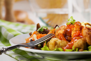 Fried chicken pieces in batter with sweet and sour sauce