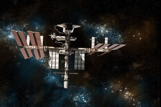 The International Space Station with the space shuttle docked on against a background of stars.