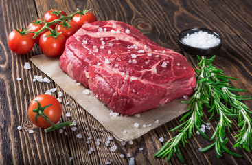 Raw marbled meat steak Ribeye on dark wooden background