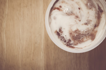 fruit yogurt jar on a wood background close view