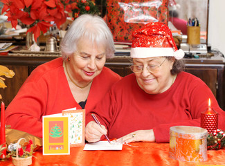senior ladies writing Christmas card
