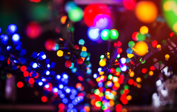 Colorful Christmas illumination in city street, close up photo