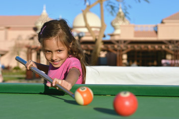 little girl Playing billiards