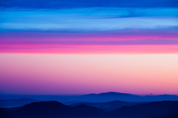 Beautiful pink sky with layered hills