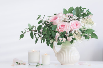 bouquet of roses with candles