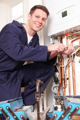 Engineer Servicing Central Heating Boiler