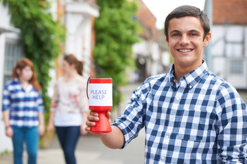 Teenage Boy Collecting For Charity In Street