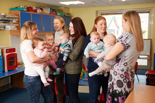 Group Of Mothers With Babies Meeting At Playgroup