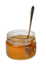 Glass jar with honey on white background