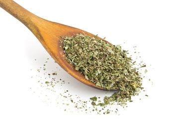 Dried oregano on wooden spoon