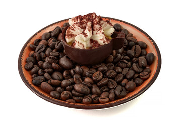 chocolate coffee cup dessert with cream on coffee beans inside a small dish on white background