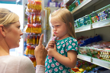 Child Having Arguement With Mother At Candy Counter