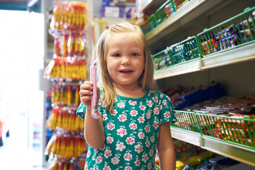 Happy Child At Candy Counter Of Supermarket