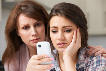 Mother Comforting Daughter Being Bullied By Text Message