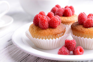 Delicious cupcakes with berries on table close up