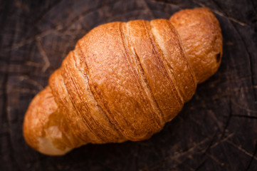 Fragrant croissants lie on a wooden table