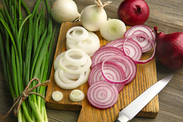 Composition of onions and garlic on wooden background, close up