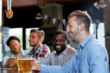 Young men drinking beer in pub