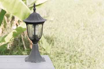 Small lantern in a garden on the wooden bridge