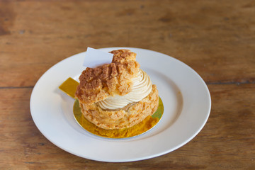 Eclair coffee cream in a dish on a wooden floor.
