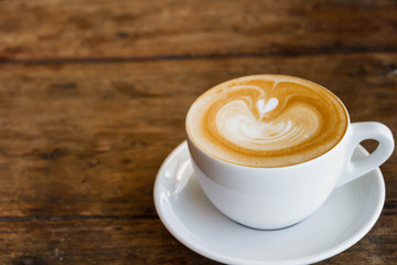 Close up blue cup of Coffee, latte on the wooden table