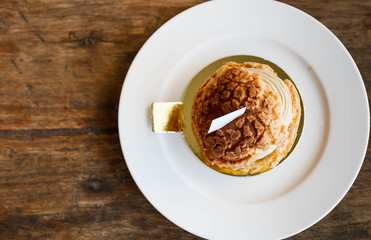 Eclair coffee cream in a dish on a wooden floor.