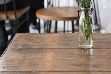 Flowers in a glass vase on a wooden table.