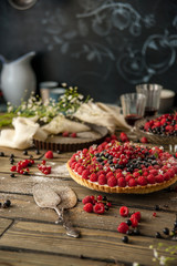 Obraz na płótnie Canvas Beautiful and delicious berry tart is on the table