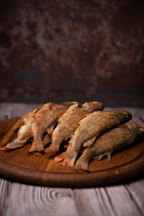 Fried fish lying on the Boards on the wooden table