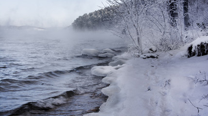 Winter Russian lake - water, mist, snow forest and mountains
