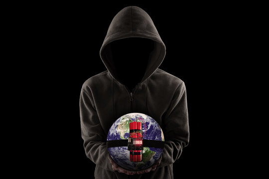 Faceless man holding time bomb with globe against black background