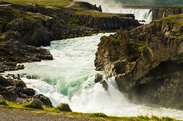 Fototapeta na wymiar Glacial river with Godafoss waterfall in background, Iceland