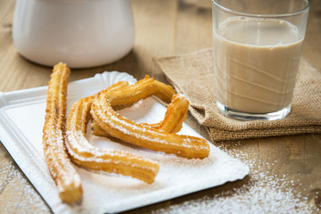 Churros with coffee with milk and sugar