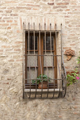 Fototapeta na wymiar Simple barred window in Italy