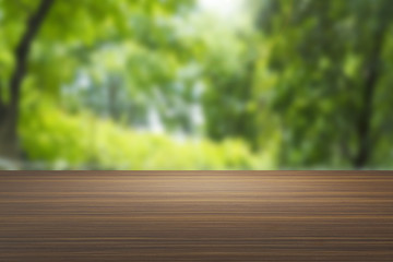 Wood table in the green nature background for your artwork