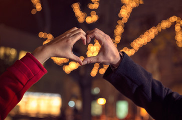 couple making heart shape with hands