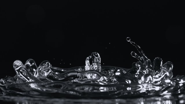 Water surface bouncing and making splash and ripple. Shot with high speed camera, phantom flex 4K. Slow Motion. Unedited version is included at the end of clip.