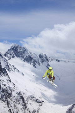 Flying skier on mountains. Extreme sport