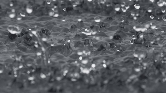Water surface bouncing and making splash. Shot with high speed camera, phantom flex 4K. Slow Motion. Unedited version is included at the end of clip.