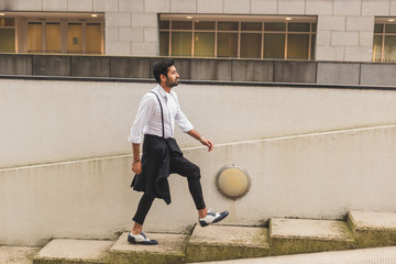 Handsome Indian man posing in an urban context