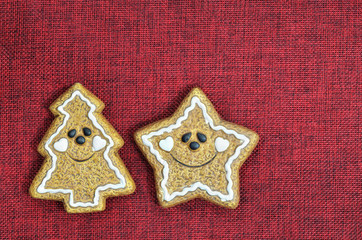 Christmas Background / close up of two  Christmas cookies, star shape and Christmas tree, smiling, ...