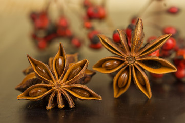 Star anise and cumin seeds on a wooden board